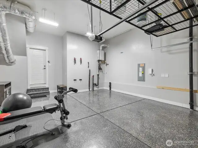 2-car garage has professionally epoxy floor. Perfect for home gym too! Note the extra storage above.