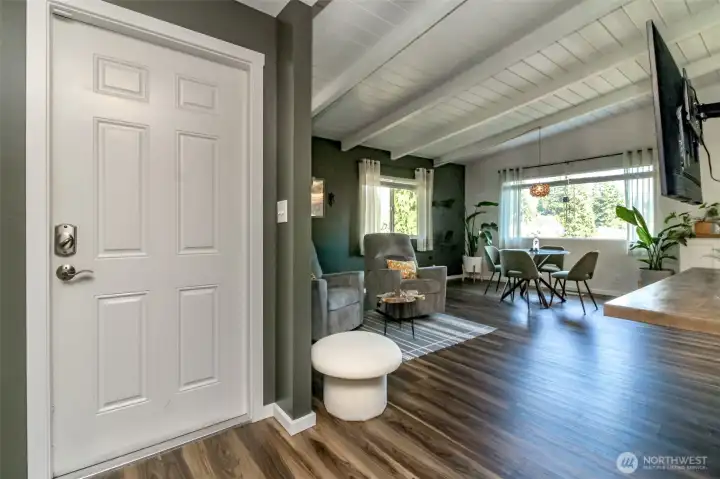 Open concept living room with exposed beam ceilings.