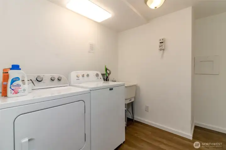New washer & dryer included in the laundry room complete with a utility sink.