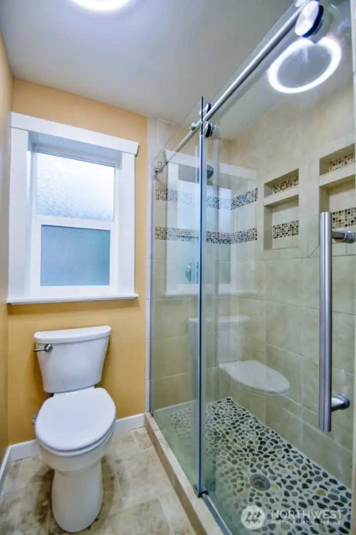 Pirmary 3/4 bath with tile floor that is heated.