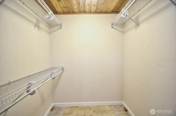 Primary walk in closet with heated tile flooring