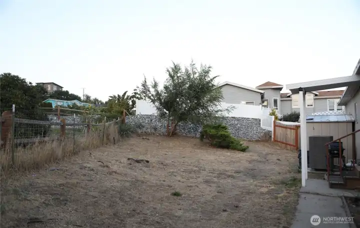 View of the fully fenced backyard, offering privacy and security