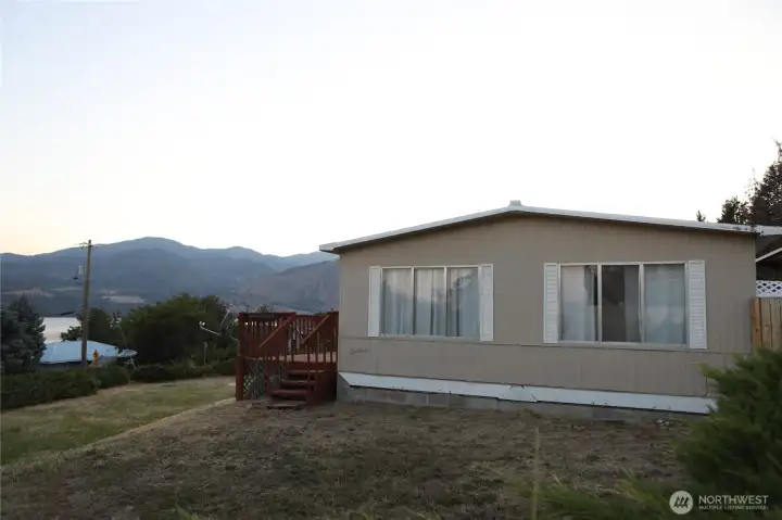 Scenic view overlooking the front yard with breathtaking vistas of Lake Chelan and the surrounding vineyards.