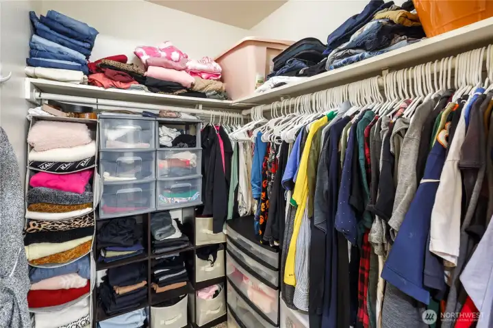 Walk-in closet has lots of room and shelving.