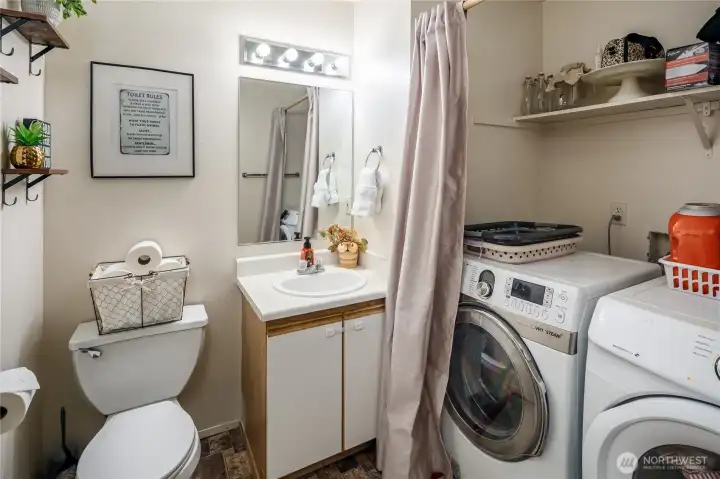 Main floor guest bath and laundry area. Washer & dryer stay with the home.