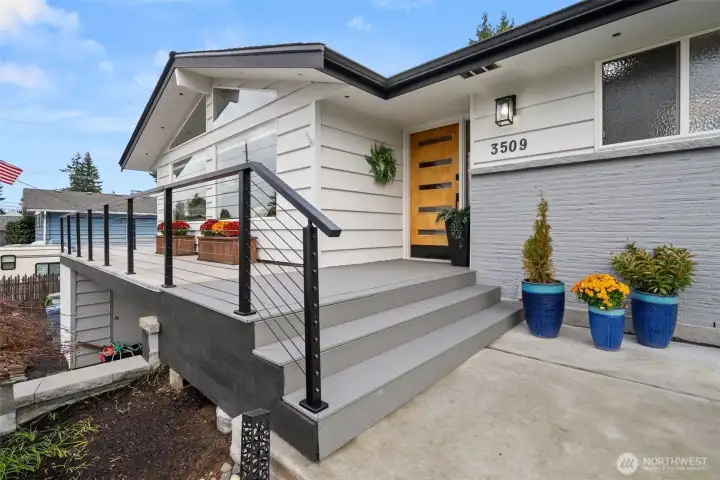 tylish covered front porch invites guests to step out of the rain.