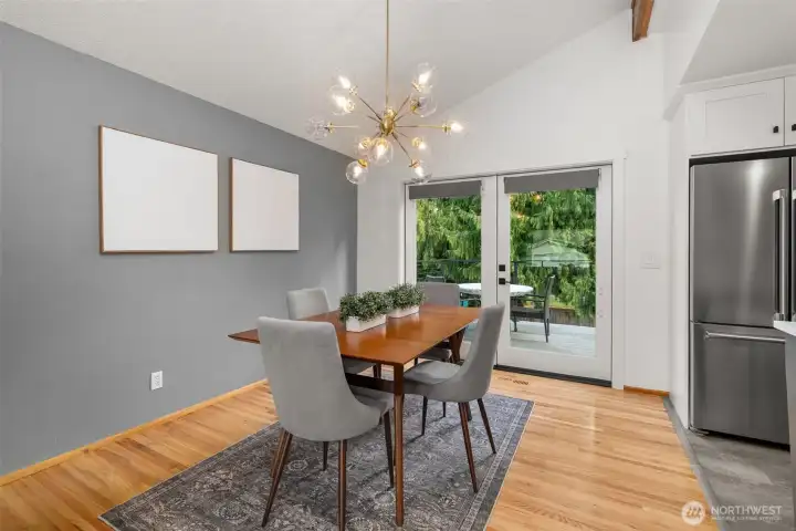 Pretty dining room helps connect guests to the chef - room for a crowd here, too - how big is your table? French doors were added to access the new huge deck; now you have indoor and al fresco dining options!