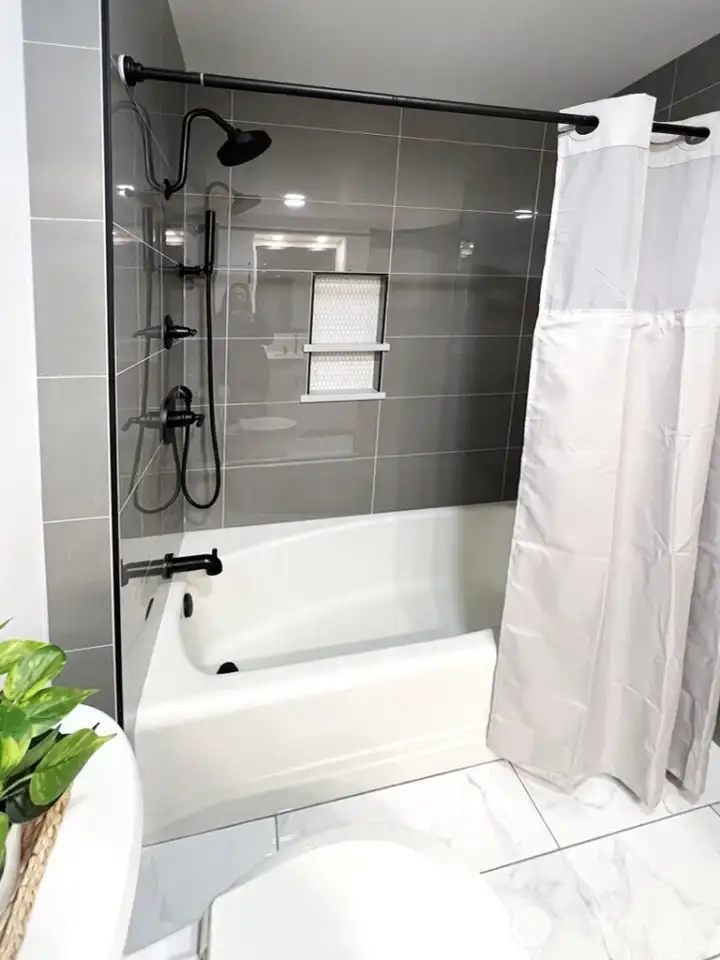 A peek at the beautiful tiled tub surround and new plumbing fixtures.