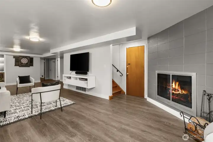 At the base of the stairs you'll find a HUGE recreation/game room, with the 2nd original fireplace. The door to the right of the stairs leads to the 400 sf carport, which is enclosed on 3 sides and has locking storage also.