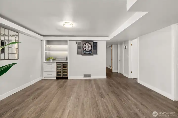 Just beyond the conversation lounge is the game area, with a fabulous built-in bar & beverage fridge. This may just become your new favorite space for hosting!