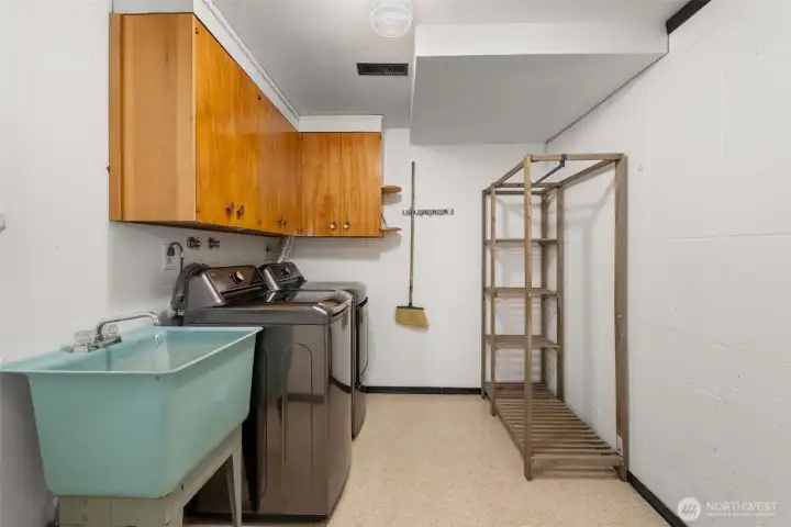 The basement is also where you'll find the laundry room, with its retro sink & cabinets, and loads of extra storage space. Washer/dryer included!