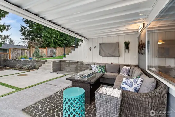 Just outside the rec room door you'll find this lovely covered patio - room for your largest outdoor furniture set, and crowd of friends. Great spot for a fire table, and 365 days/yr of fresh air - oh, and, yep - that's a tv hanging on the wall....Seahawks around the fire anyone?