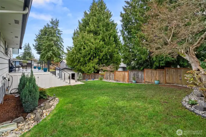 Looking back toward the deck, patios and pool shed - ample natural lawn here, too. When you tour, DON'T miss the dry storage space accessed from this side, under the deck! There is SO much storage here.