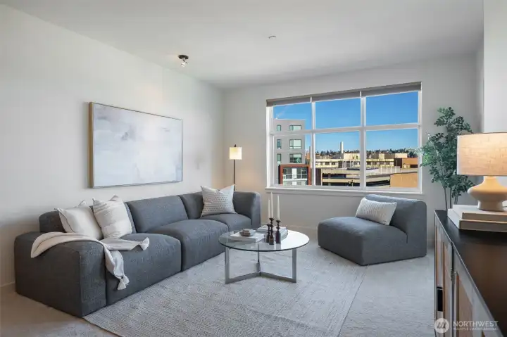 This light-filled residence features an expansive open-concept layout, perfectly positioned to capture sweeping urban vistas of Phinney Ridge, the iconic Ballard Bridge, and the Queen Anne skyline—with a coveted peek-a-boo glimpse of majestic Mount Rainier on clear Pacific Northwest days. Walls of windows invite in natural light, creating an airy, uplifting ambiance that feels both vibrant and serene.