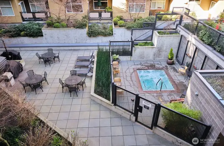 Amenities include BBQs, seating, and a spa.