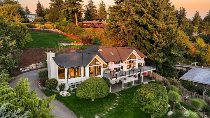 Nestled in the exclusive Edgemoor neighborhood, this stunning home sits on nearly an acre of pristine, landscaped grounds, offering both space and privacy in a highly sought-after location.