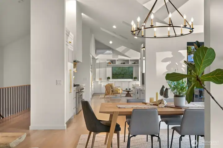 The formal dining room, bathed in abundant natural light, flows seamlessly into the kitchen, where custom cabinetry elevates both style and functionality. This harmonious connection makes it ideal for entertaining or enjoying everyday moments, with a layout that encourages togetherness and ease.
