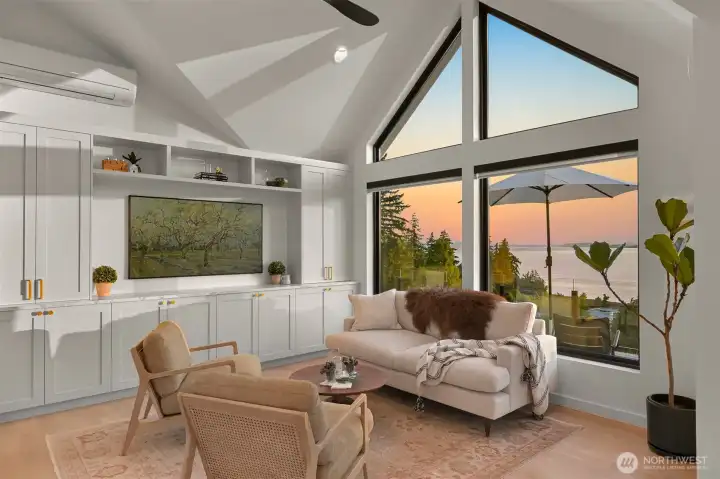 Featuring framed windows that showcase dazzling views of the bay and surrounding islands, the lounge is both stylish and functional, complete with built-ins and a TV for cozy movie nights or social gatherings.