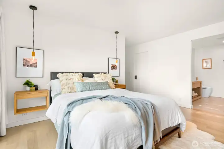 The luxury primary ensuite is a retreat in itself, offering direct access to a west-facing deck through sliding glass doors, where you can step out to take in the golden hues of the sunset or enjoy a quiet morning with a cup of coffee.