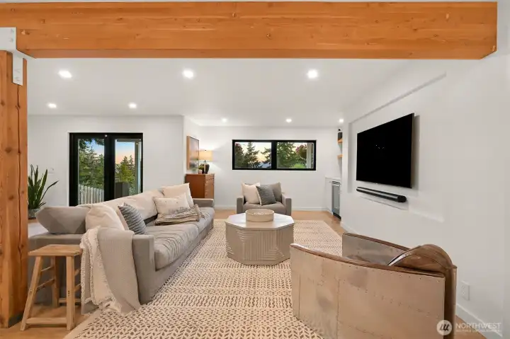 The suite also showcases exposed beams and wood floors, adding a touch of warmth and character to its modern design.