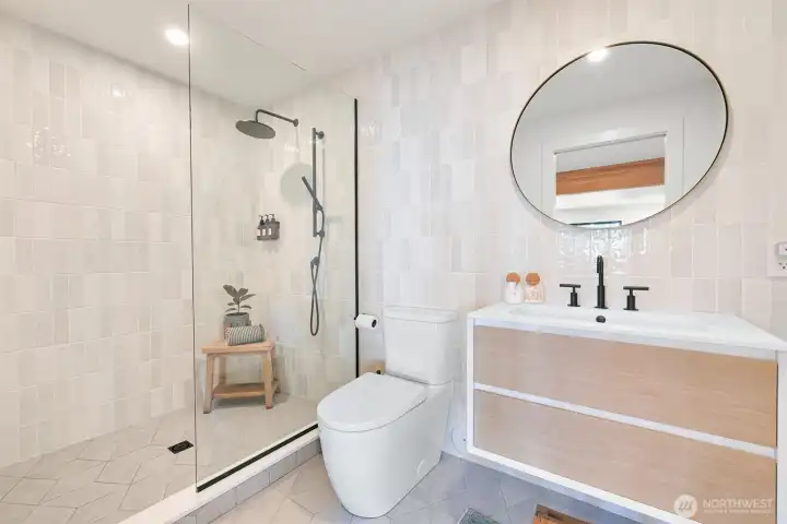 A gorgeous bathroom with tiled floors and a slider for added privacy elevates the suite’s appeal, offering both style and comfort.