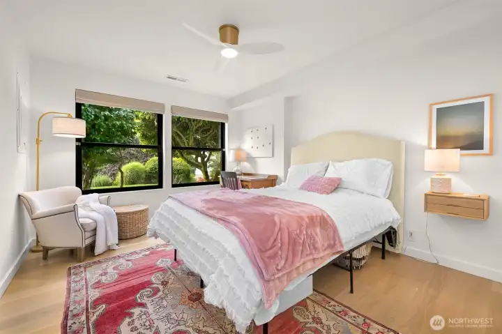 Spacious guest bedrooms feature gleaming hardwood floors, creating an inviting and elegant space to make visitors feel truly at home.