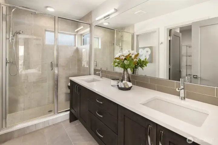 Spa-inspired design with a glass shower, double vanity, and clean modern finishes