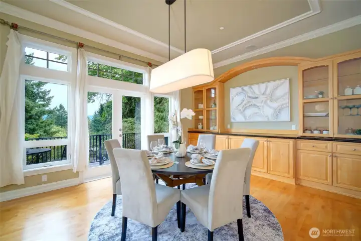 Exceptional formal dining area. Enjoy entertaining with room for 12-14 dinner guests, the space is grand. Sips outside on the adjacent, sunlit balcony. Peek-a-boo Eastside views, built-in shelving for all your entertaining.