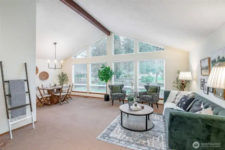 Stunning western wall of windows peaks at the vaulted ceiling