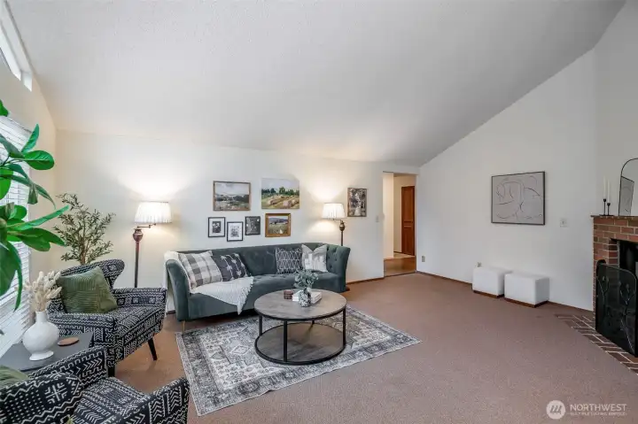 Natural light and vaulted ceilings enlarge the already spacious living room
