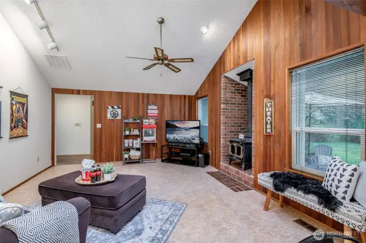 Wood burning stove, rustic paneling, easy clean floors- bring on the praty vibes!