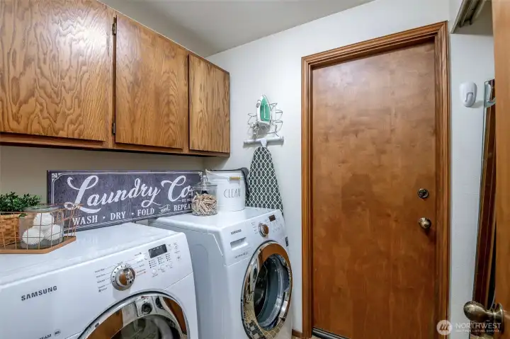 Utility room off hall & garage has newer appliances and is surrounded by storage solutions.