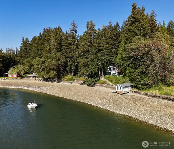 View of beach looking back at the property, house and boathouse