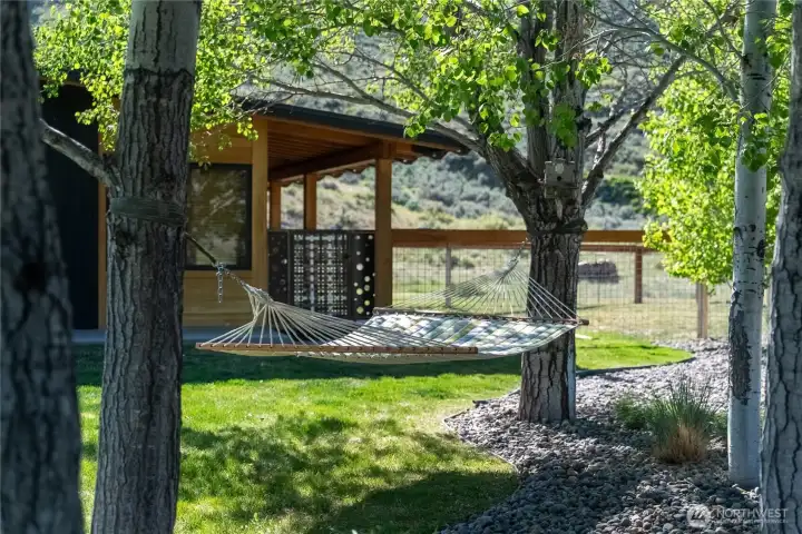 The entrance to the guest house is just beyond a shady aspen grove and takes advantage of remarkable views.