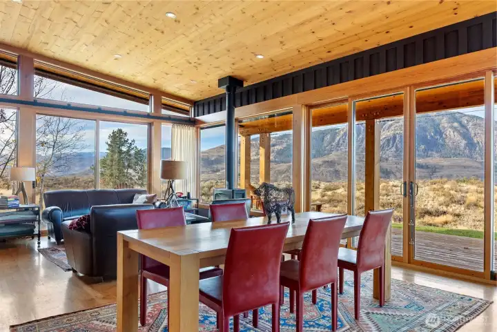 The great room brings the outside in with floor to ceiling windows.