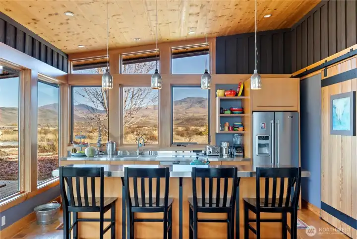 The kitchen has a large counter bar to watch the chef at work!