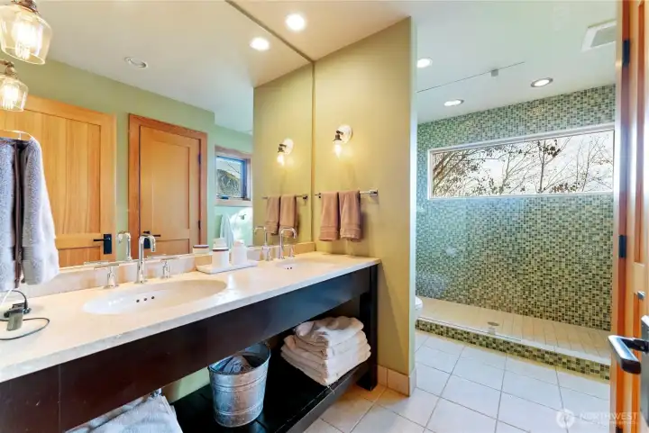 The primary bedroom has a double-sink and a heated tile floor.
