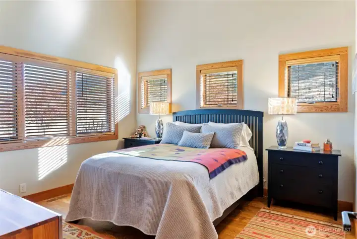 Both bedrooms feature wooden louvered shades.