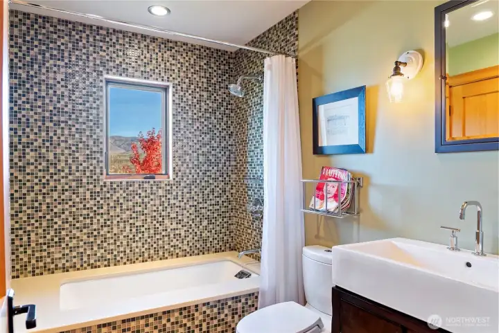 The custom tile work and strategically placed view windows are a key feature of the home.