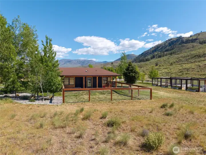 The guest house has its own large porch for enjoying the views, and adjoining fenced garden space.