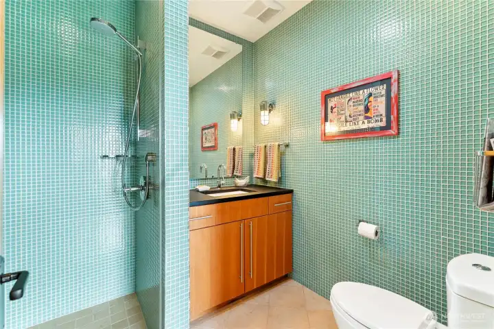Bright floor-to-ceiling tile work can be found in the guest house bathroom as well!