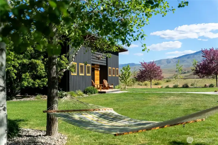 The home is surrounded by green lawns and drought-resistance landscaping, as well as this mature aspen grove - the most perfect spot for relaxing in your hammock.