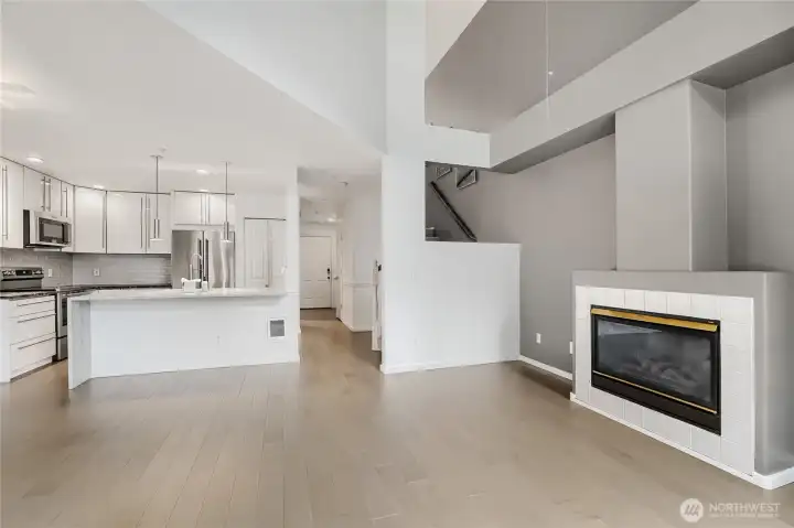 Warm gas fireplace anchors the living room. Engineered hardwood floors throughout the main level.