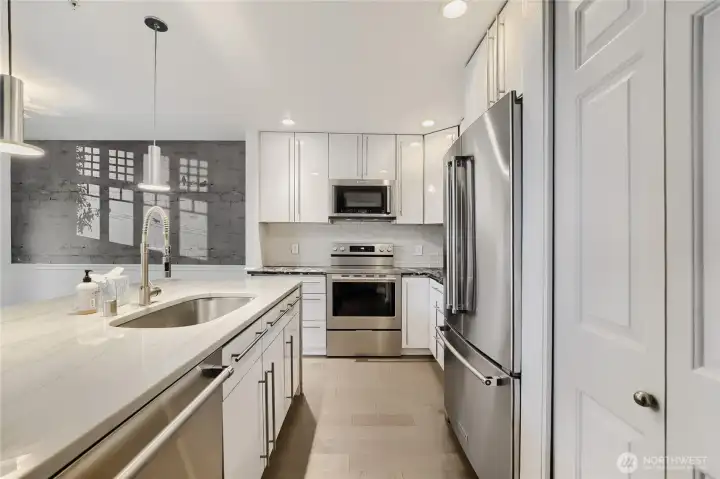 Stainless steel appliances complete the modern look. Pantry storage enhances everyday usability.