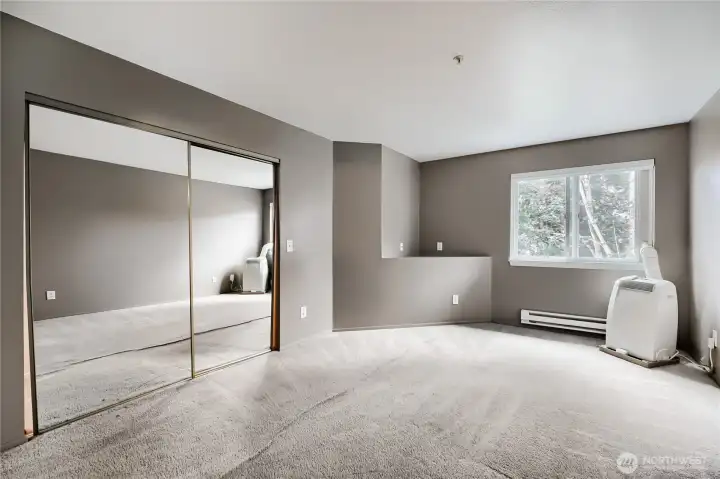 Primary suite with private bath and mirrored closet.