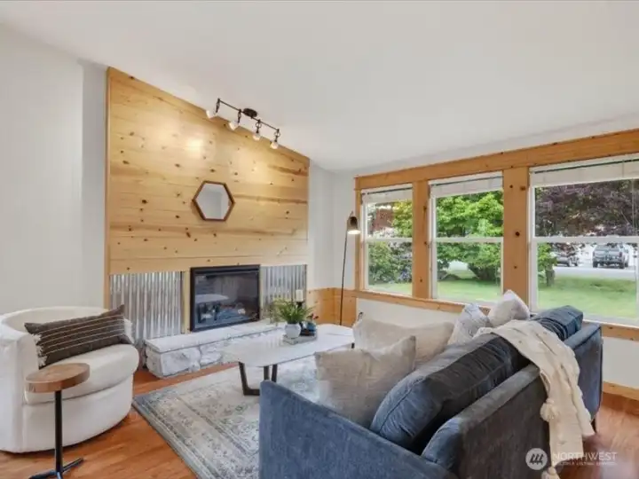 The wood wall and trim add so much warmth to this spacious living room. The wood wall and trim add so much warmth to this spacious living room.