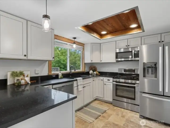 The kitchen is so spacious and the white shaker cabinets really make the black granite counters and backsplash "pop"! The kitchen is so spacious and the white shaker cabinets really make the black granite counters and backsplash "pop"!
