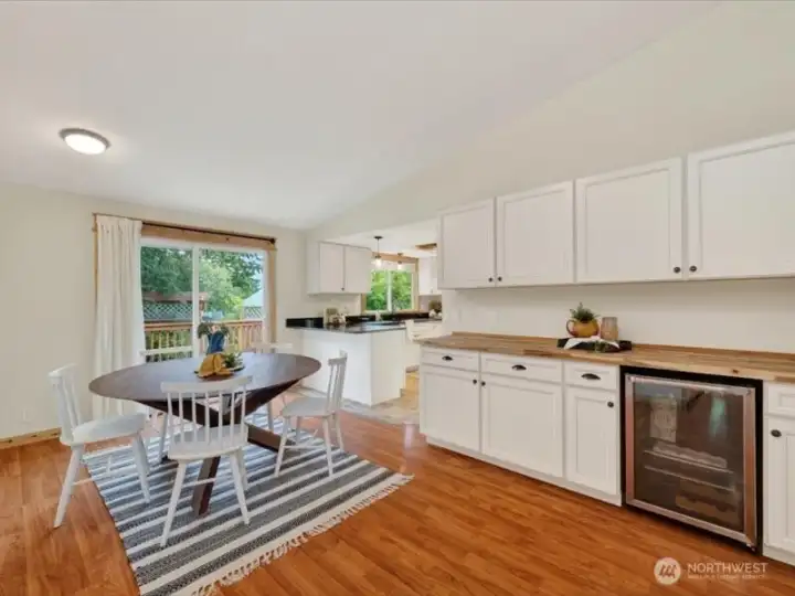 There is a beverage refrigerator off the dining room and the sliding doors lead to the big rer yard and back deck. There is a beverage refrigerator off the dining room and the sliding doors lead to the big rer yard and back deck.