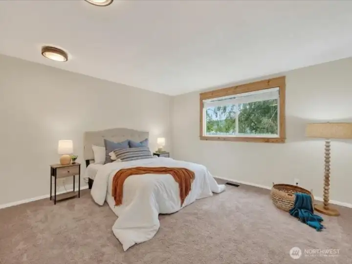 Another view of the spacious primary bedroom with the lovely trees in the rear yard. Another view of the spacious primary bedroom with the lovely trees in the rear yard.