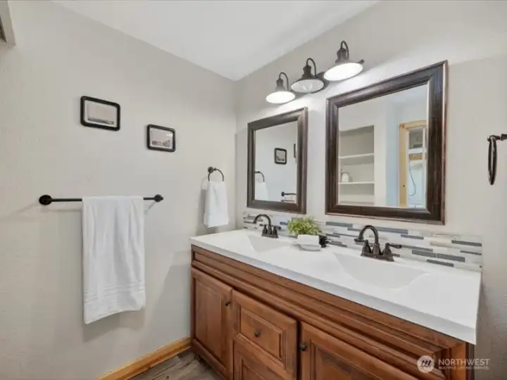 The primary bathroom has been nicely updated and has a dual sink vanity with a tile backsplash. The primary bathroom has been nicely updated and has a dual sink vanity with a tile backsplash.